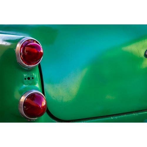 Detail of two red tail lights on classic green car in Trinidad-Cuba